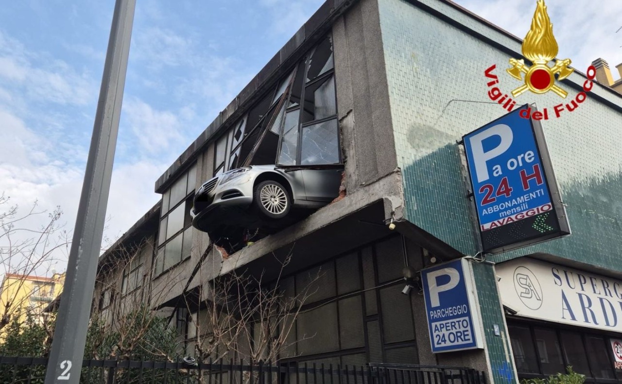 Sfonda il vetro con l’auto in un garage multipiano: la vettura resta sospesa nel vuoto a otto metri di altezza